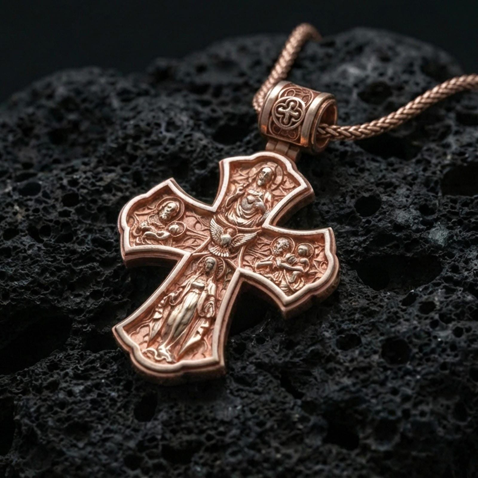 Holy Trinity cross pendant on volcanic stone in a rose gold plated look, bringing warmth to the engraved sacred motifs.
