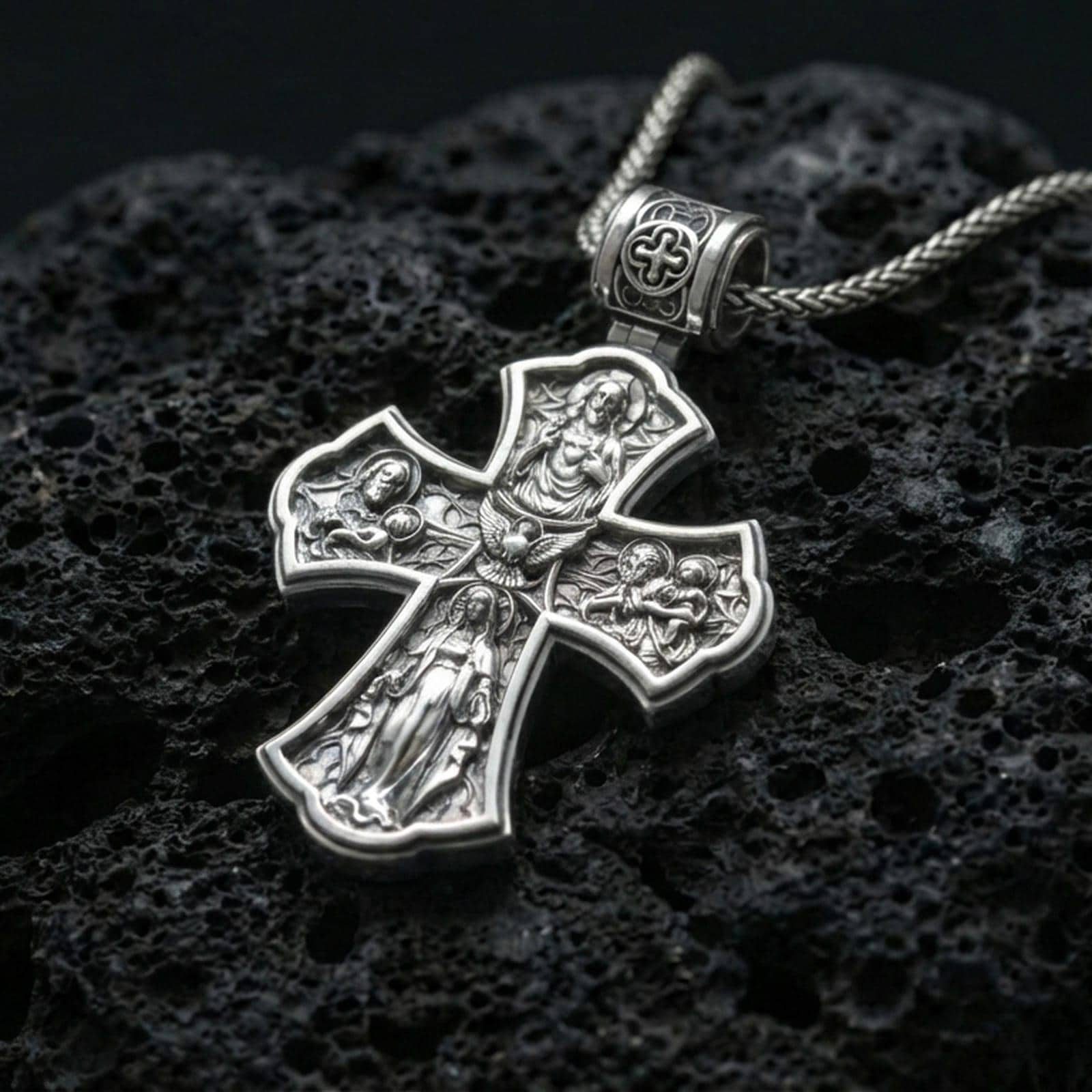 925 sterling silver Holy Trinity cross pendant on volcanic rock with a clean polished shine highlighting the carvier edges.