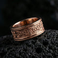 Load image into Gallery viewer, Vintage scrollwork band ring on volcanic stone with a rose gold plated look, showing crisp ornamental details and smooth rounded profile.
