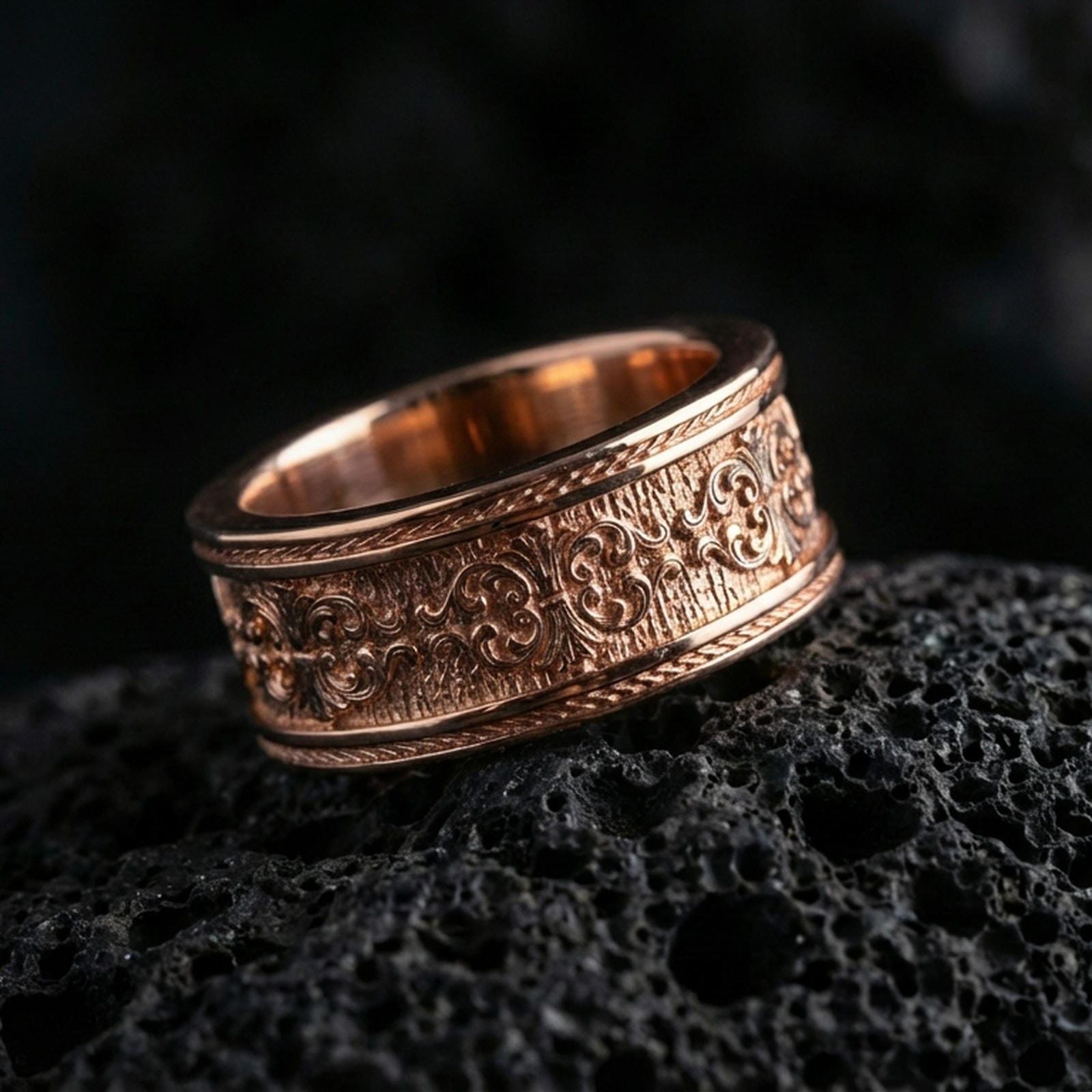 Vintage scrollwork band ring on volcanic stone with a rose gold plated look, showing crisp ornamental details and smooth rounded profile.