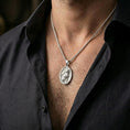 Load image into Gallery viewer, A polished 925 sterling silver cat pendant worn on the neck, minimalist oval medallion with a clean feline design.

