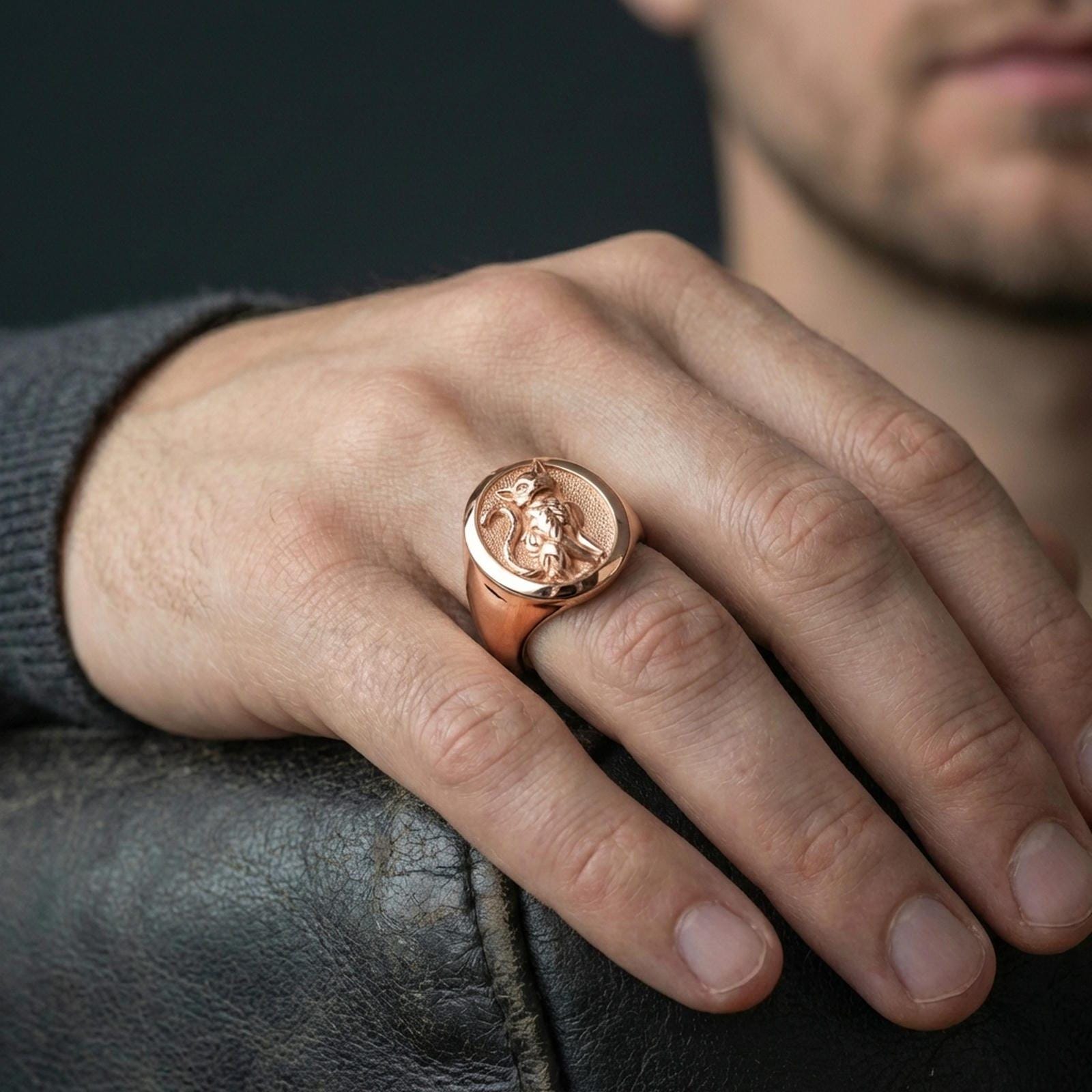 A rose gold plated feline signet ring worn on the finger, sleek everyday jewelry with a refined cat emblem.