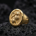 Load image into Gallery viewer, A gold plated cat signet ring on black volcanic stone, featuring a raised feline figure in a clean oval frame.
