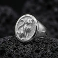 Load image into Gallery viewer, A 925 sterling silver feline signet ring on black volcanic rock, polished silver highlights showing the sculpted cat details.
