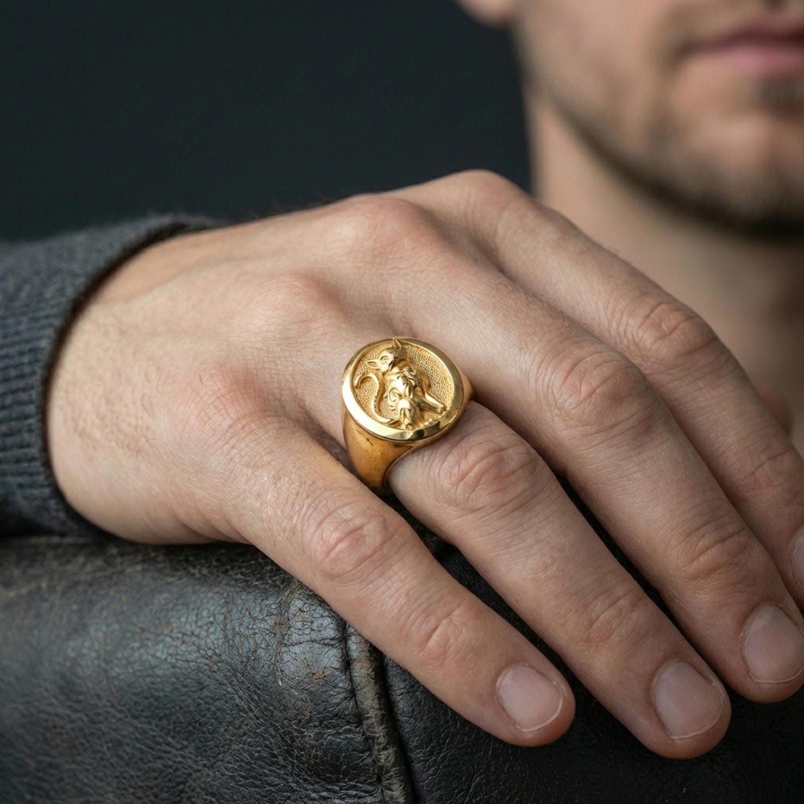 A gold plated cat signet ring worn on the finger, unisex statement ring style with a bold feline totem.