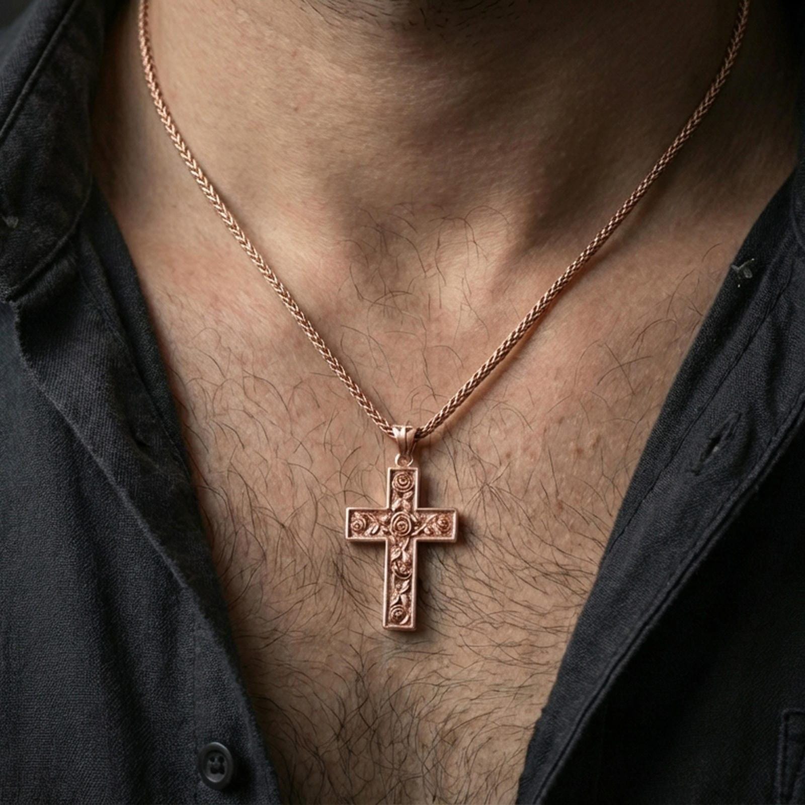 Rose gold plated cross pendant with rose engravings worn on the neck in a detailed lifestyle shot with a warm and refined presentation