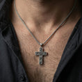 Load image into Gallery viewer, Oxidized rose cross pendant worn on the neck in a lifestyle jewelry shot, styled against the chest for a bold and devotional look
