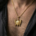 Load image into Gallery viewer, Gold plated Saint Michael inspired pendant with sword and angel wings worn on the neck in a premium lifestyle composition with bold Christian styling
