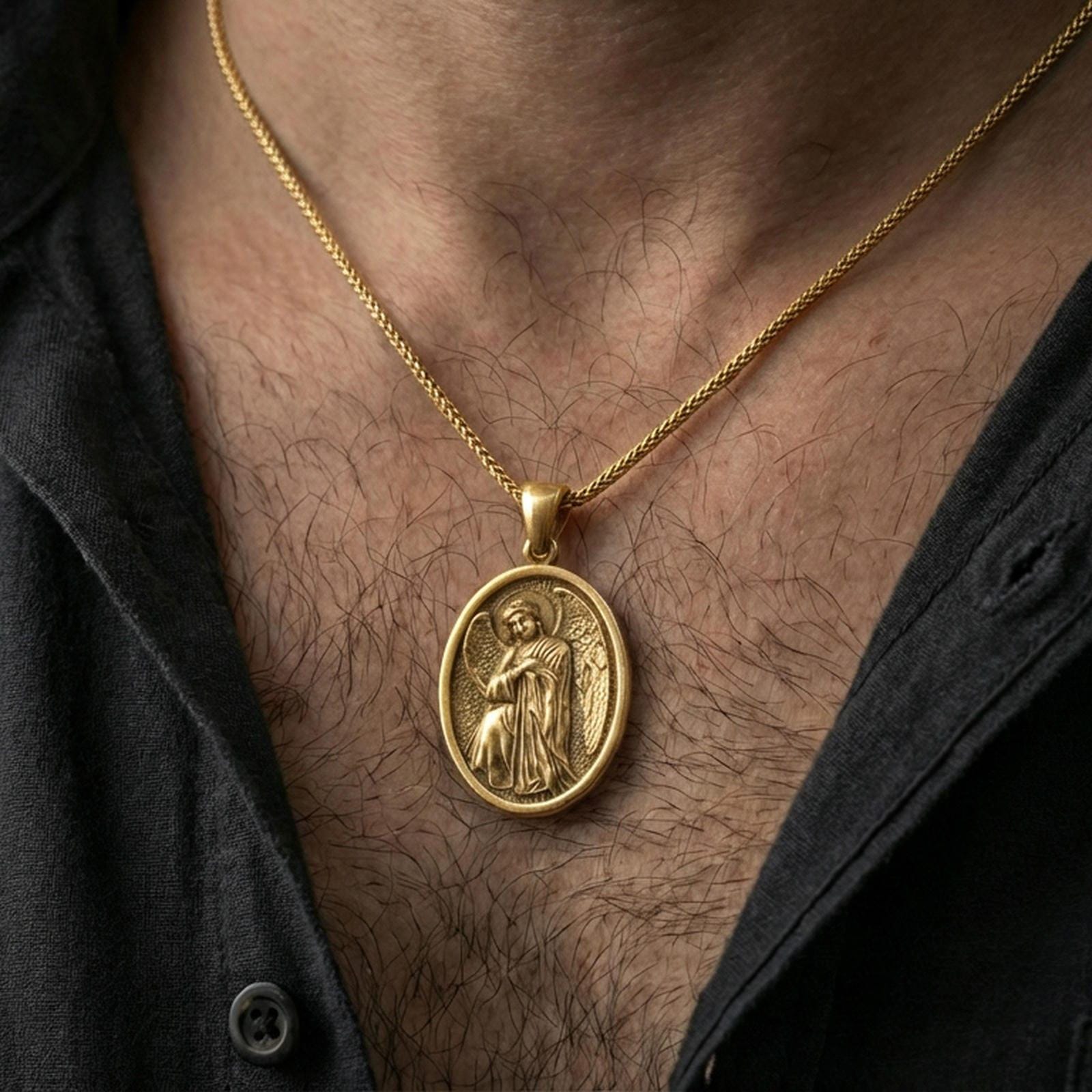 Gold plated angel medallion pendant worn on the neck in a premium lifestyle composition with elegant spiritual jewelry styling