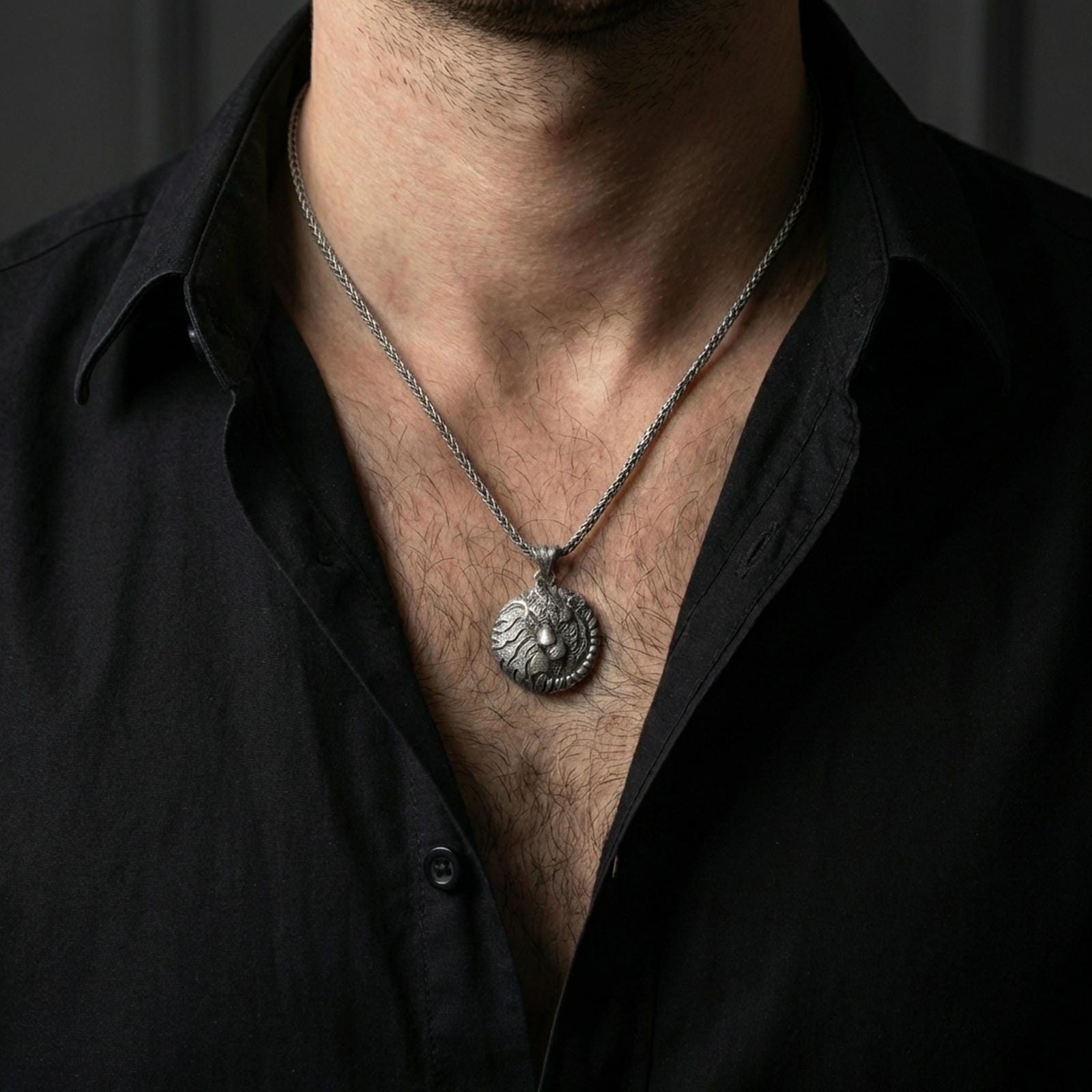 Oxidized sleeping tiger pendant with curled jungle cat design worn on the neck in a lifestyle jewelry shot, styled against the chest for a bold and symbolic statement look