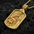 Load image into Gallery viewer, Gold plated Madonna and Child pendant with crowned Mary figure and detailed devotional relief showcased on black volcanic rock in a refined macro jewelry image

