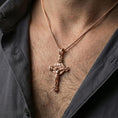 Load image into Gallery viewer, Rose gold plated Jesus cross pendant with ornate religious detailing worn on the neck in a refined lifestyle shot with a warm and elegant presentation
