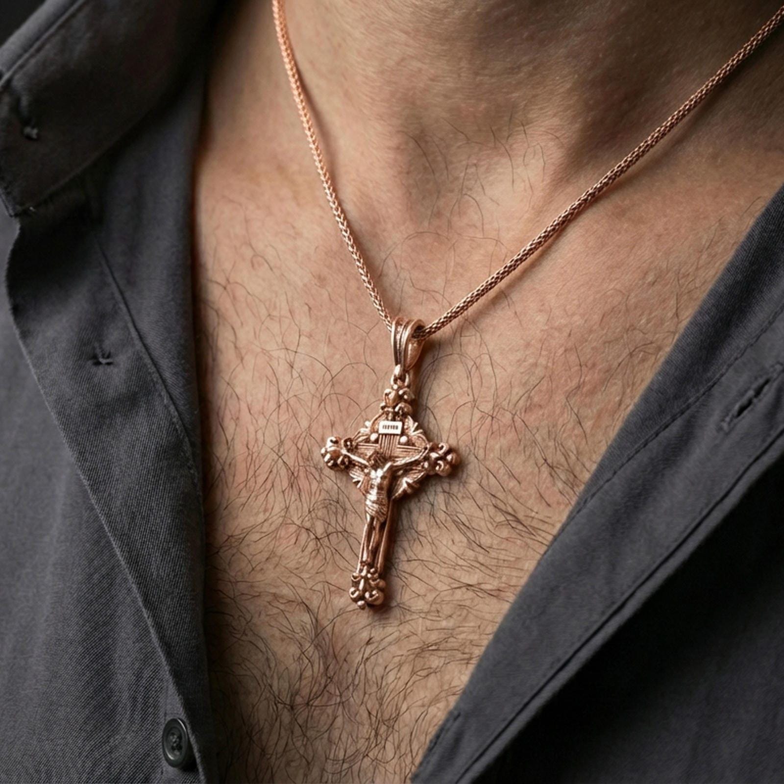 Rose gold plated Jesus cross pendant with ornate religious detailing worn on the neck in a refined lifestyle shot with a warm and elegant presentation