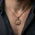 Load image into Gallery viewer, Rose gold plated Lion of Judah spinner necklace worn on the neck in a refined lifestyle shot with a warm and powerful presentation
