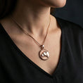 Load image into Gallery viewer, Rose gold plated lioness necklace with refined feline portrait, round medallion form, and feminine predator-inspired symbolism worn on the neck in a refined lifestyle shot with a warm and sophisticated presentation
