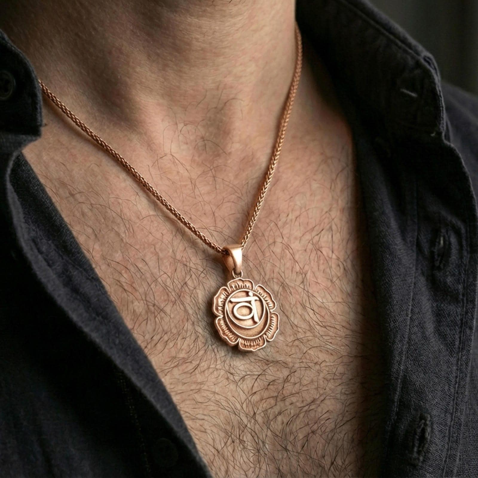 Rose gold plated chakra pendant with lotus flower outline and symbolic center worn on the neck in a refined lifestyle shot with a warm and balanced presentation