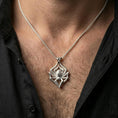 Load image into Gallery viewer, Polished silver spider necklace with detailed leg texture and realistic body silhouette worn on the neck in a close lifestyle frame, highlighting the striking arachnid design and refined craftsmanship
