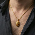 Load image into Gallery viewer, Gold plated polygonal lion pendant with sharp geometric lion face, faceted modern design, and spirit animal symbolism worn on the neck in a premium lifestyle composition with bold animal-inspired jewelry styling
