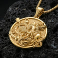 Load image into Gallery viewer, Gold plated Saint George necklace with warrior on horseback, dragon motif, and Corinthians detail showcased on black volcanic rock in a refined macro jewelry image
