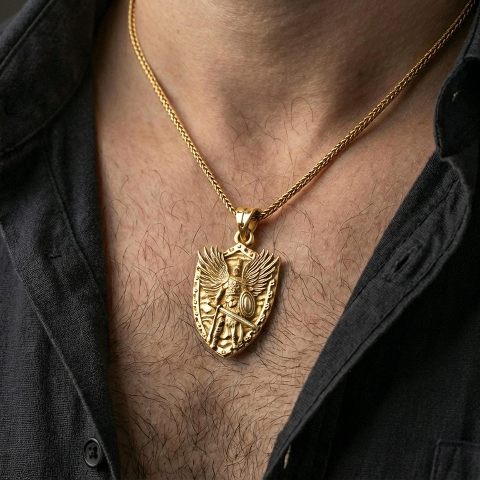 Gold plated Archangel Michael necklace with armored angel design and shield motif worn on the neck in a premium lifestyle composition with strong Christian jewelry styling