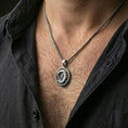 Load image into Gallery viewer, Oxidized crocodile pendant necklace worn on the neck, shown in a dark lifestyle portrait with an open shirt and masculine styling.
