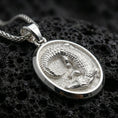 Load image into Gallery viewer, Sterling silver crocodile pendant necklace in polished silver on a dark volcanic rock surface, captured in a centered macro product shot.
