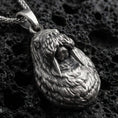 Load image into Gallery viewer, Sterling silver walrus pendant necklace with an oxidized finish resting on textured volcanic rock, captured in a close-up premium studio composition.
