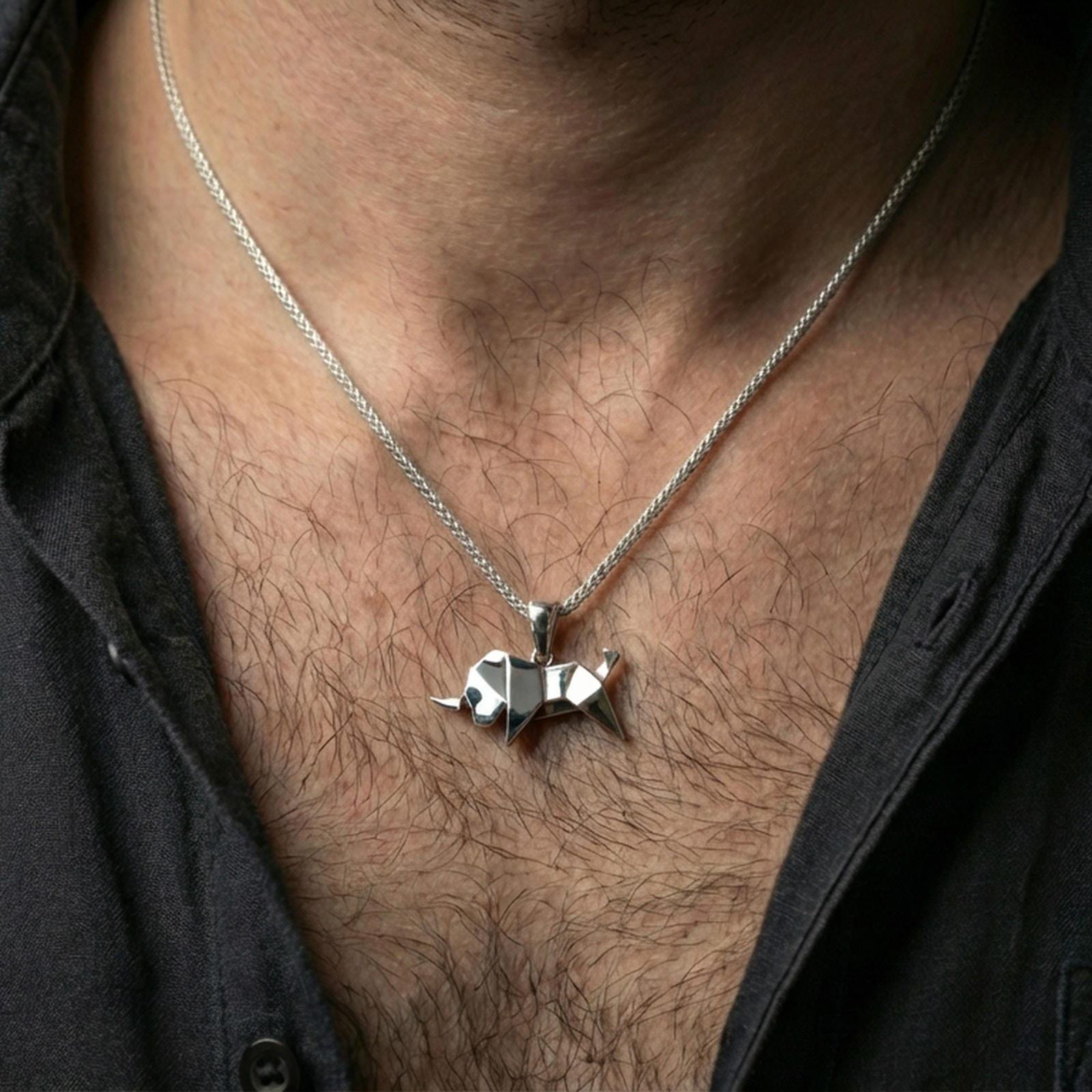 Polished silver origami elephant pendant necklace worn on the neck, shown against the chest in a clean and elegant everyday wear composition.
