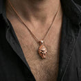 Load image into Gallery viewer, Rose gold plated gorilla head pendant necklace worn on the neck, presented in a close-up lifestyle shot with a refined masculine aesthetic.
