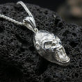 Load image into Gallery viewer, Polished silver gorilla head pendant necklace displayed on black volcanic rock, shown in a refined macro product shot with detailed facial sculpting.
