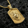 Load image into Gallery viewer, Gold plated bear pendant necklace presented on porous volcanic rock, highlighting the rectangular medallion form and sculpted bear motif in a luxurious close-up jewelry image.
