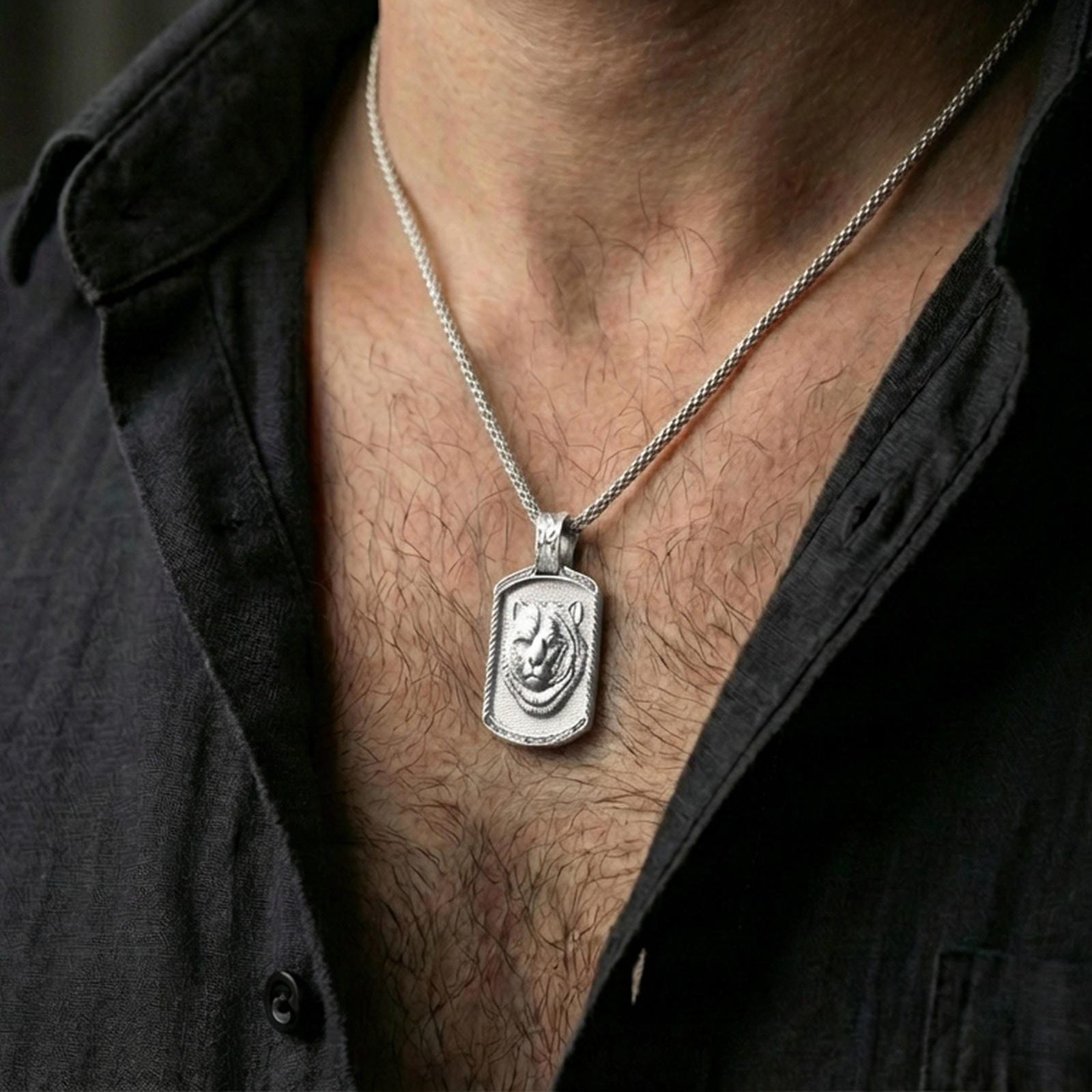 Polished silver bear pendant necklace worn on the neck, shown against the chest in a clean and elegant everyday wear composition.