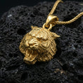 Load image into Gallery viewer, Gold plated tiger lion pendant necklace presented on porous volcanic rock, highlighting the fierce animal head design in a luxurious close-up jewelry image.
