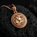 Load image into Gallery viewer, Rose gold plated horse head pendant necklace on dark volcanic rock, photographed in a detailed premium studio macro view.
