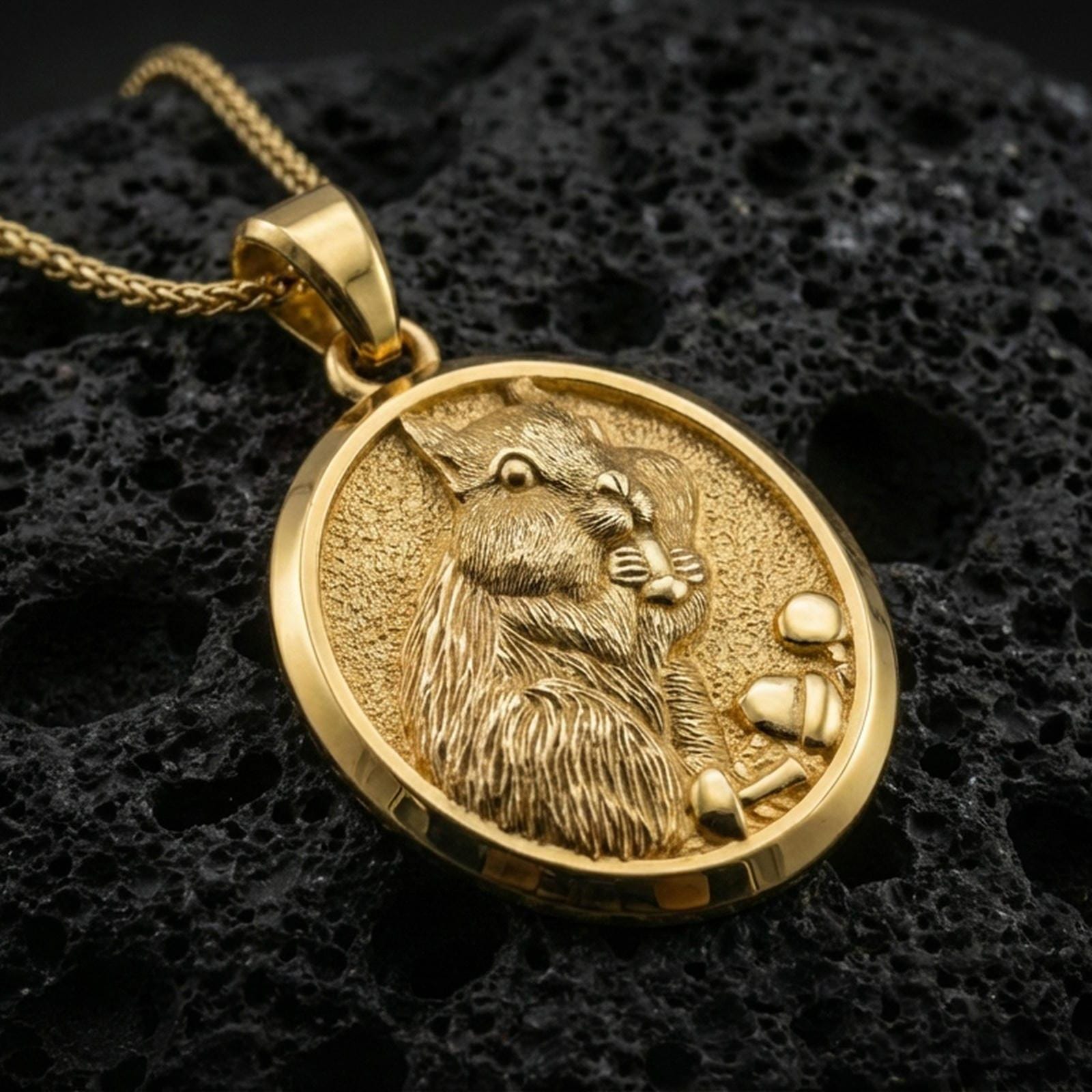 Gold plated squirrel pendant necklace presented on porous volcanic rock, highlighting the woodland animal motif in a luxurious close-up jewelry image.
