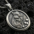 Load image into Gallery viewer, Sterling silver squirrel pendant necklace with an oxidized finish resting on textured volcanic rock, captured in a close-up premium studio composition.
