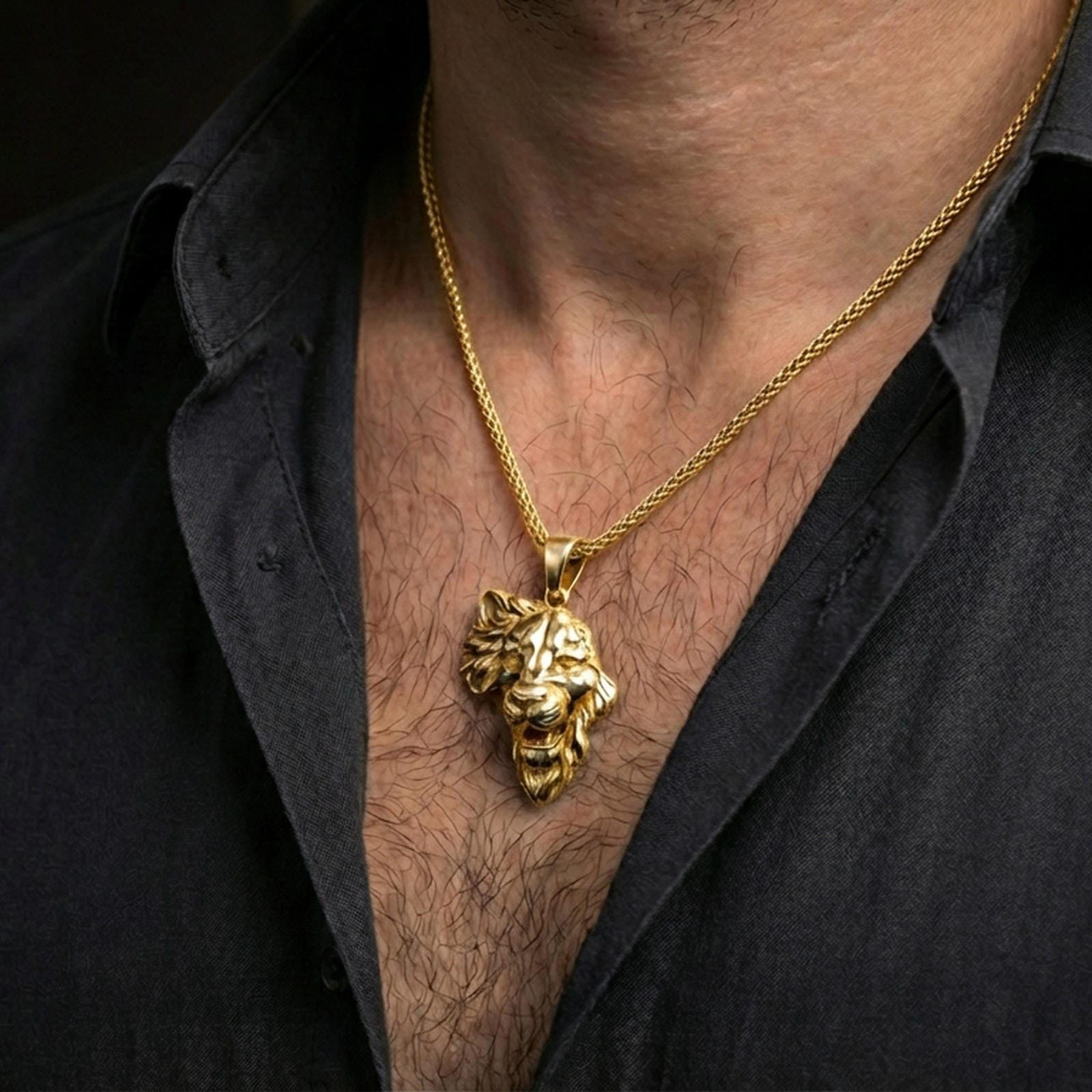 Gold plated lion head pendant necklace worn on the neck, captured on a human model in a premium dark-toned lifestyle frame.