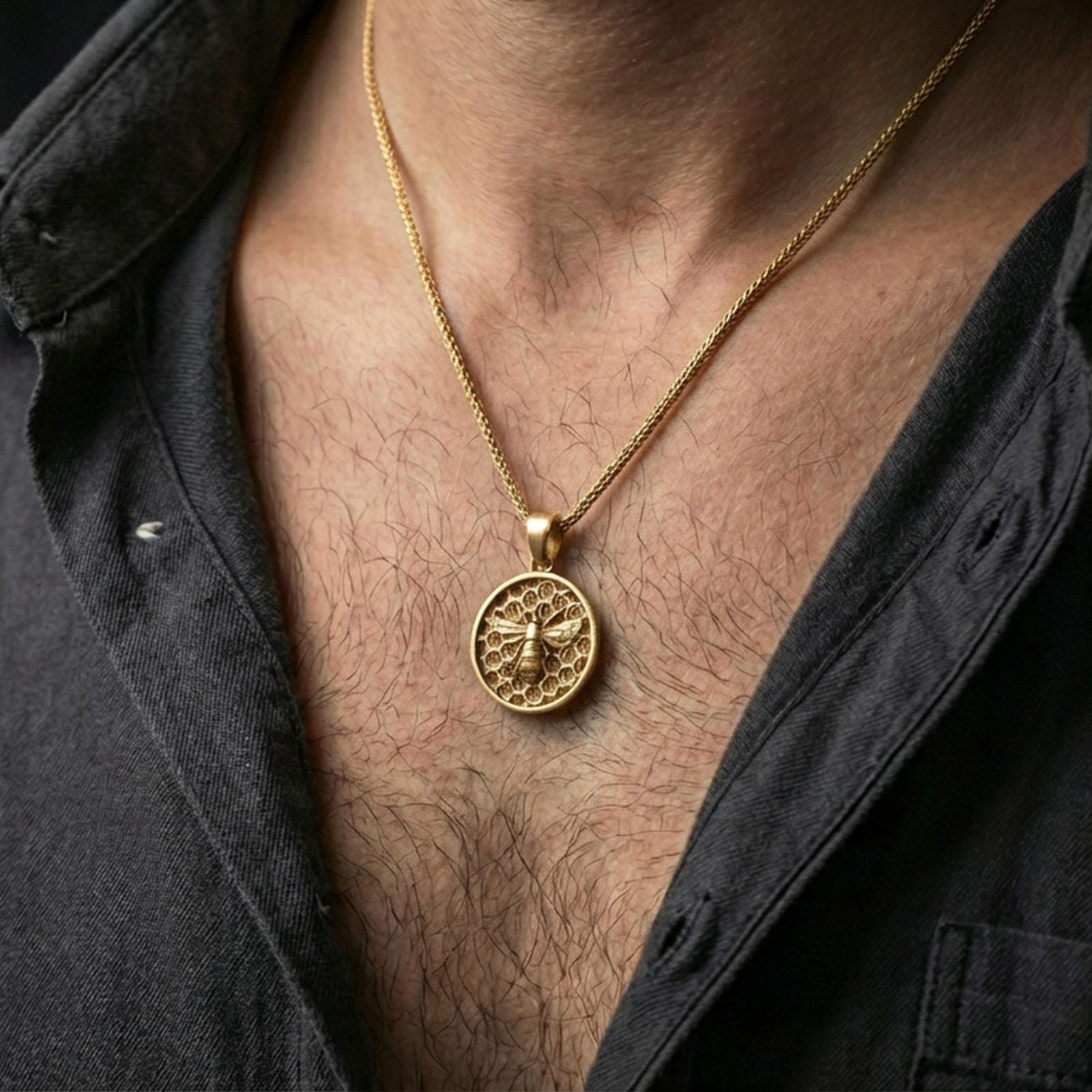 Gold plated bee pendant necklace worn on the neck, captured on a human model in a premium dark-toned lifestyle frame.