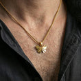Load image into Gallery viewer, Gold plated origami butterfly pendant necklace worn on the neck, captured on a human model in a premium dark-toned lifestyle frame.
