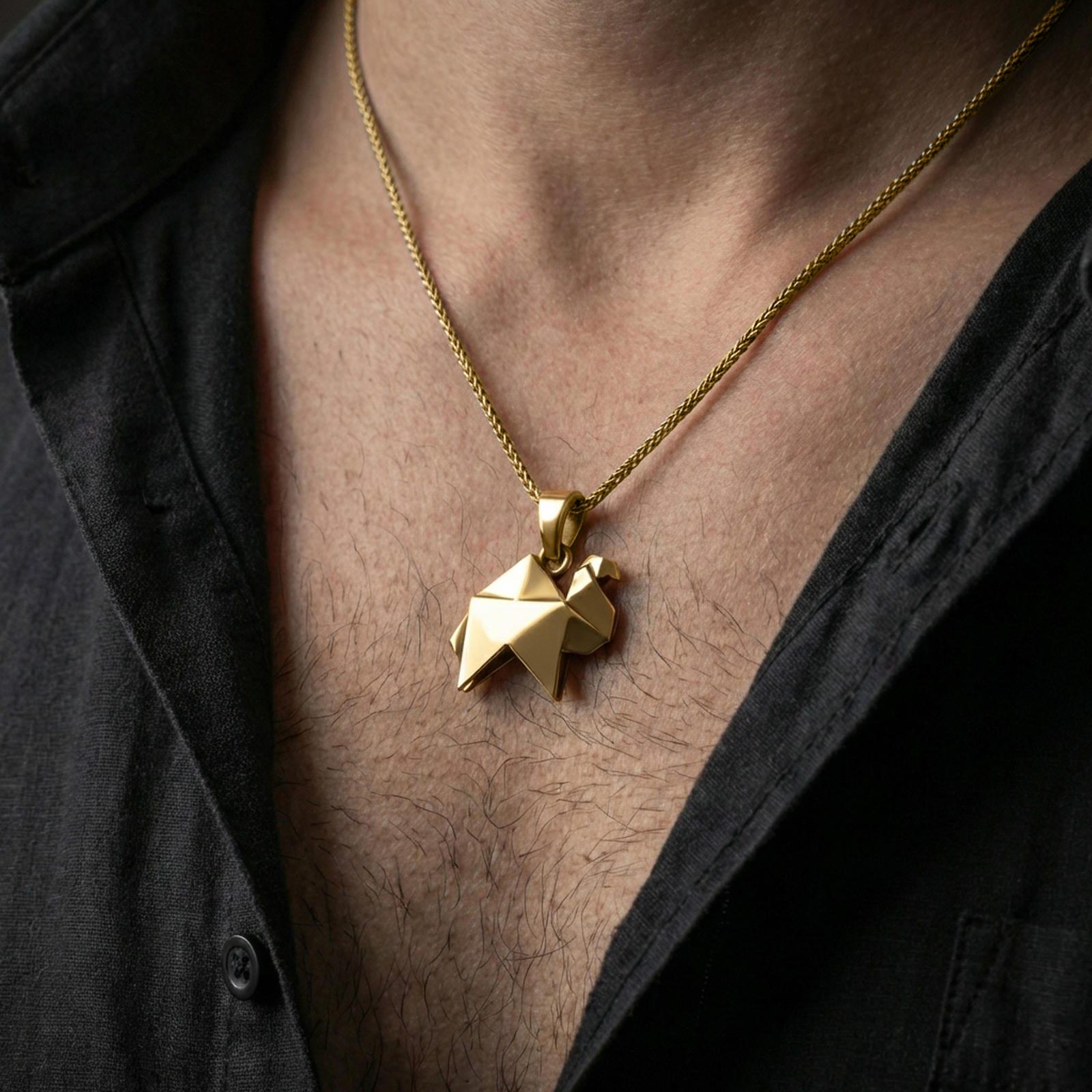 Gold plated origami camel pendant necklace worn on the neck, captured on a human model in a premium dark-toned lifestyle frame.