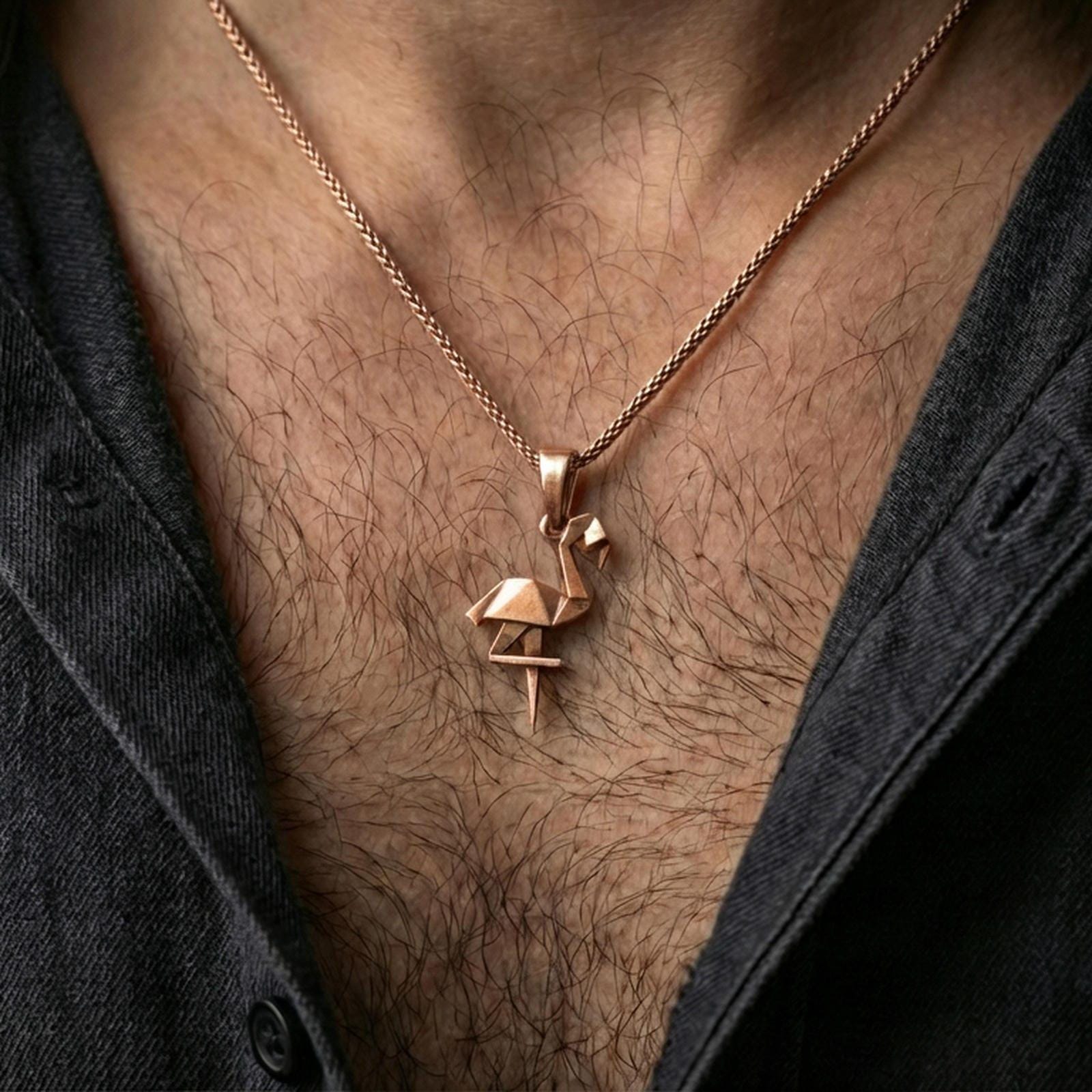 Rose gold plated origami flamingo pendant necklace worn on the neck, presented in a close-up lifestyle shot with a refined masculine aesthetic.