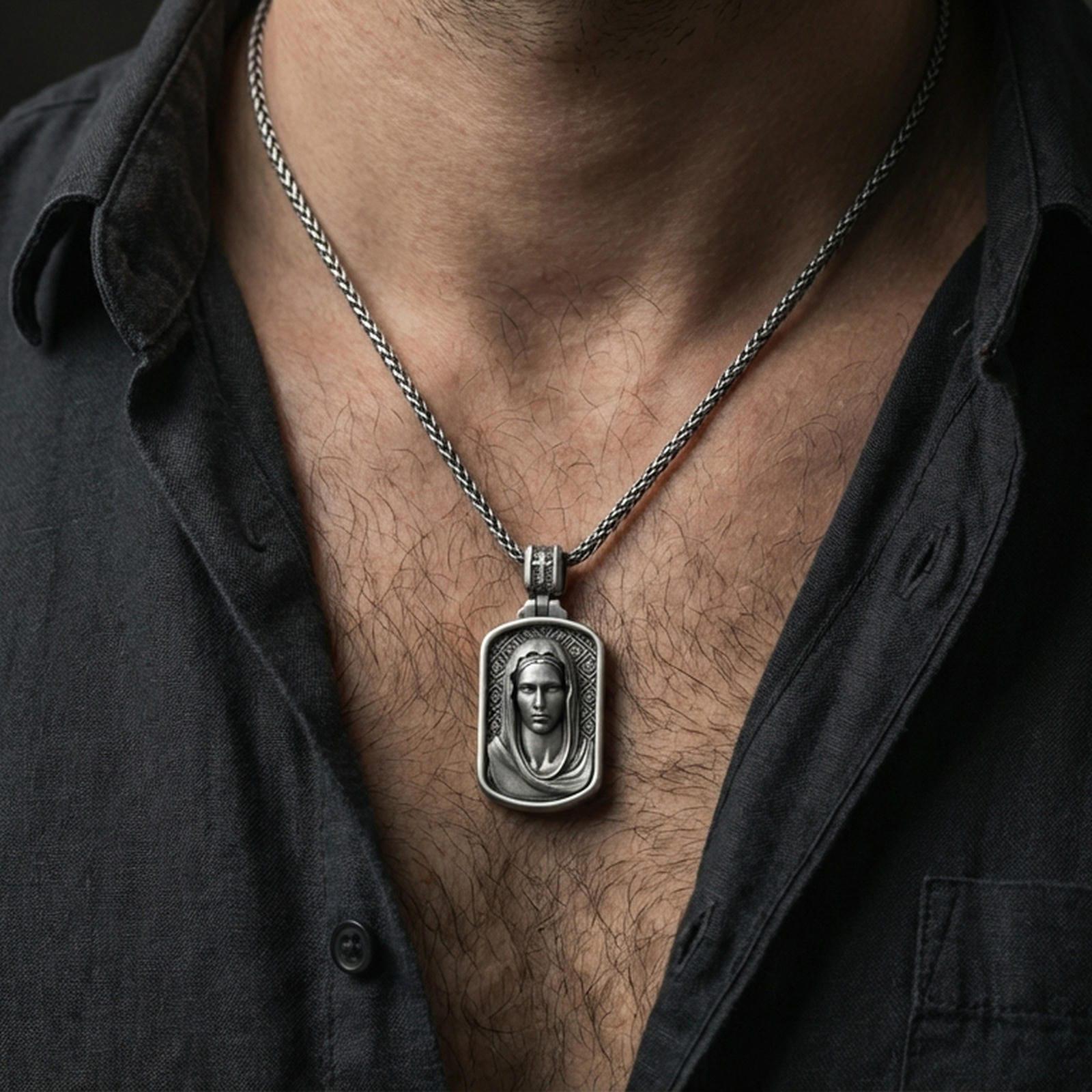 Oxidized Virgin Mary pendant with veiled portrait worn on the neck in a lifestyle jewelry shot, styled against the chest for a devotional and timeless look