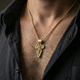 Load image into Gallery viewer, Gold plated Saint Michael pendant with winged protector motif worn on the neck in a premium lifestyle composition with strong Christian jewelry styling
