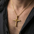 Load image into Gallery viewer, Gold plated biomechanical cross pendant worn on the neck in a premium lifestyle composition with strong futuristic gothic jewelry styling

