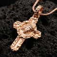 Load image into Gallery viewer, Rose gold plated Christ crucifix necklace on black volcanic stone with ornate Christian cross detailing.
