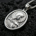 Load image into Gallery viewer, Polished silver Virgin Mary medal with veiled figure, star halo, and sacred heart detail placed on textured volcanic rock in a premium studio product shot
