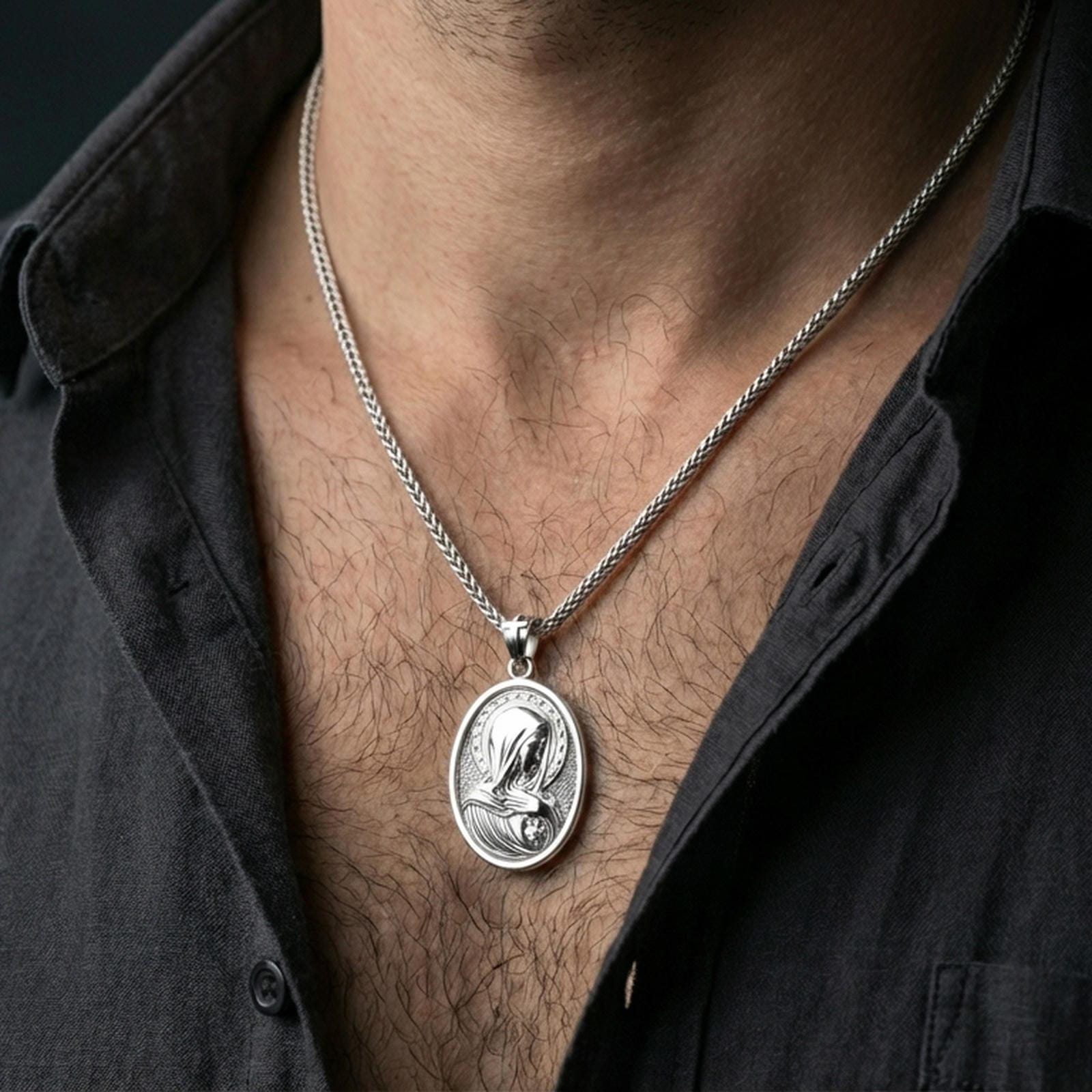 Polished silver Virgin Mary medal with star halo and sacred heart detail worn on the neck in a close lifestyle frame, highlighting the refined religious relief and oval silhouette