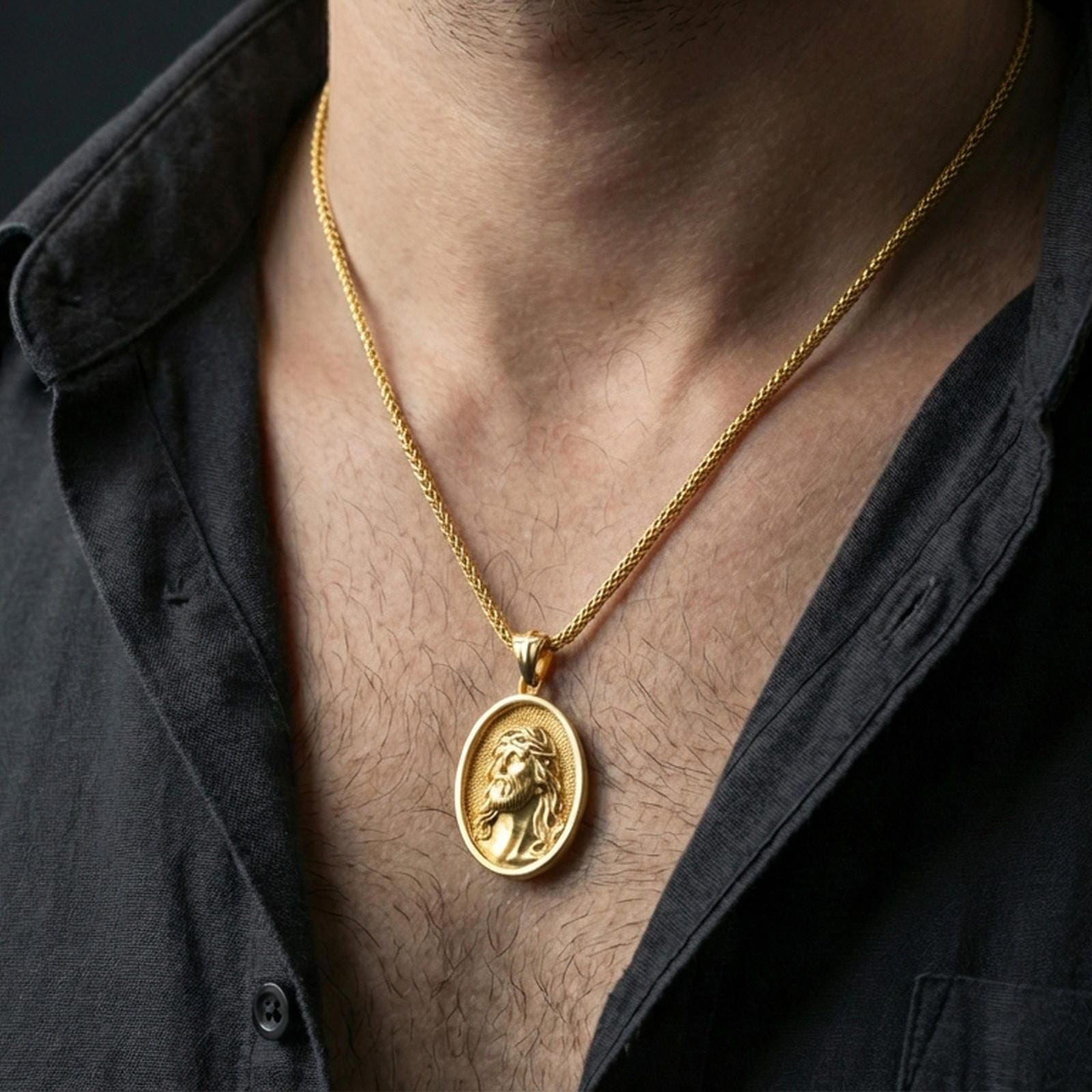 Gold plated Jesus Christ pendant with crown of thorns and oval medallion form worn on the neck in a premium lifestyle composition with timeless Christian jewelry styling