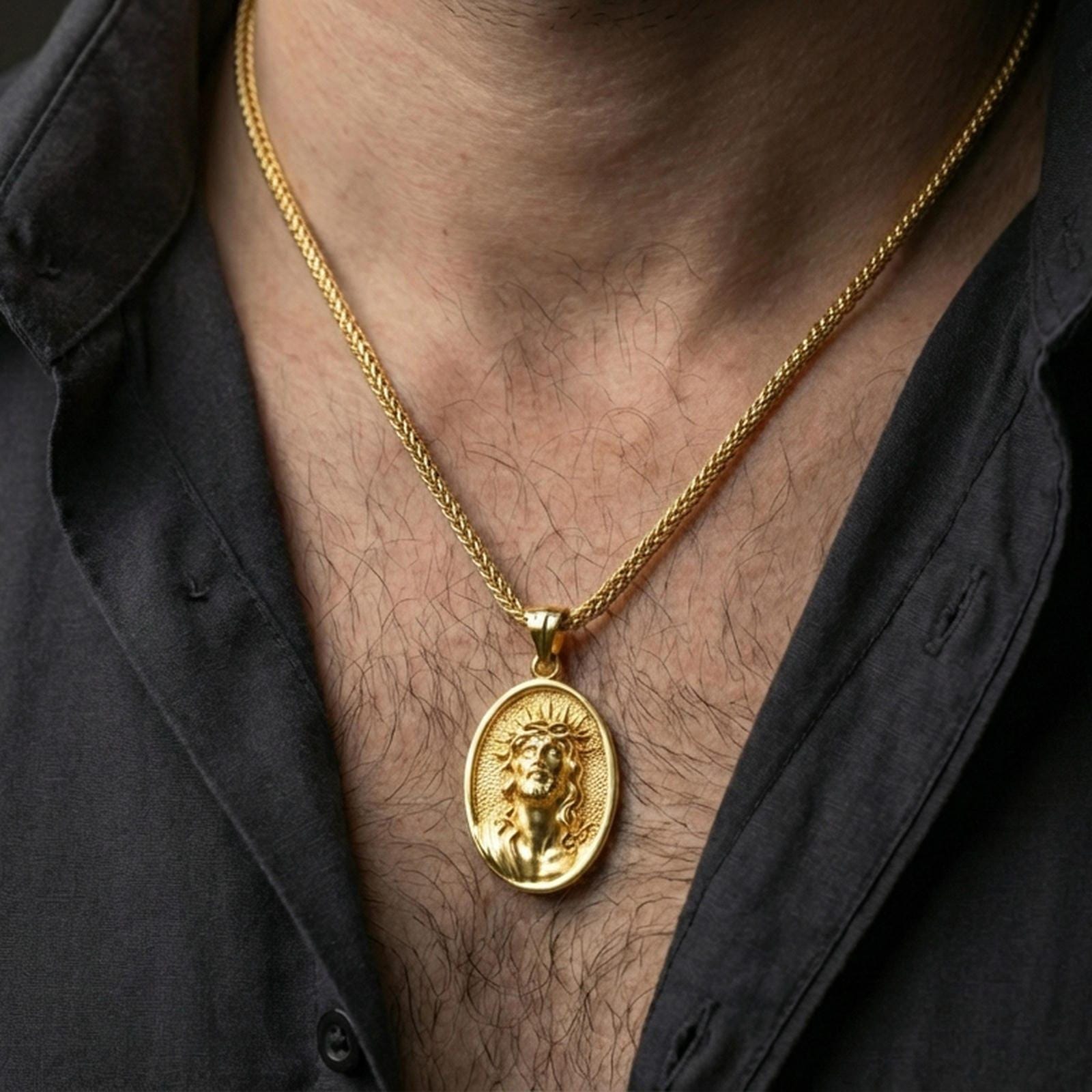 Gold plated Jesus Christ pendant with crown of thorns and halo detail worn on the neck in a premium lifestyle composition with timeless Christian jewelry styling
