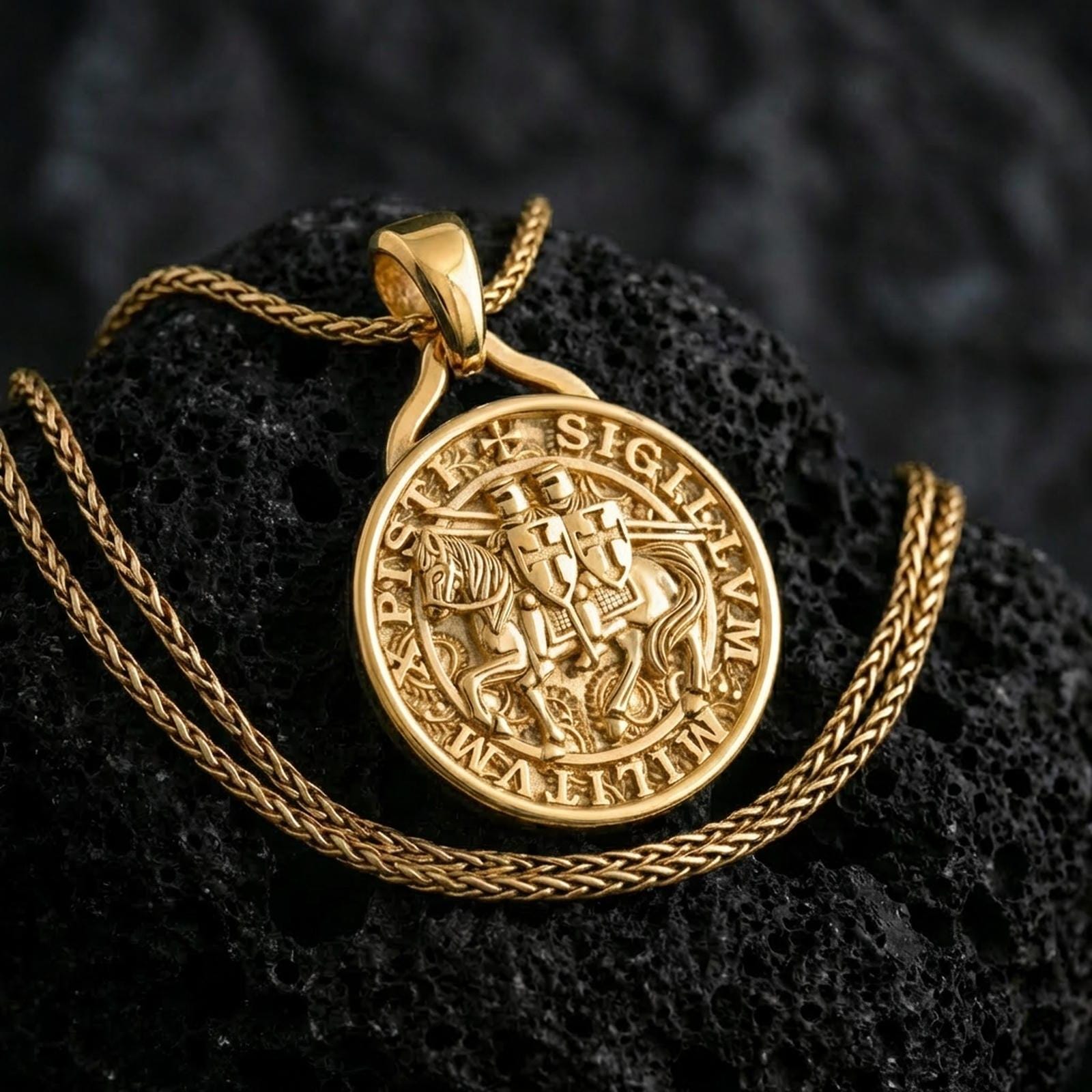 Gold plated Knights Templar seal pendant necklace presented on porous volcanic rock, highlighting the circular crusader medallion design in a luxurious close-up jewelry image.